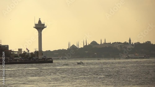 Seascape with wiews of old historical buildings of Istanbul Turkey with ancient mosques and sea lighthouse at sunset. Slow motion, Full HD video, 240fps, 1080p. photo