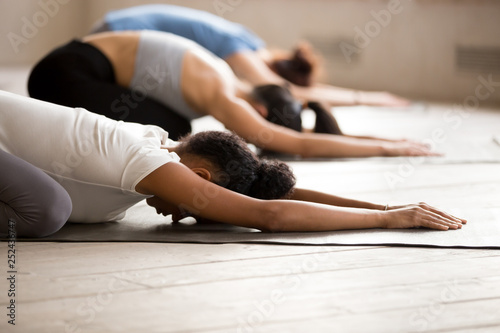 Group of women practicing yoga in Child pose