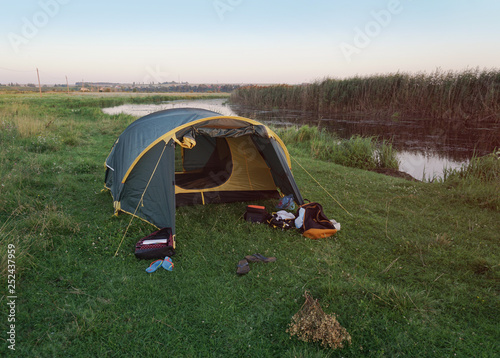 Landscape with a tent with a beautiful view near the river. Spring summer outdoor recreation. Stock background, photo