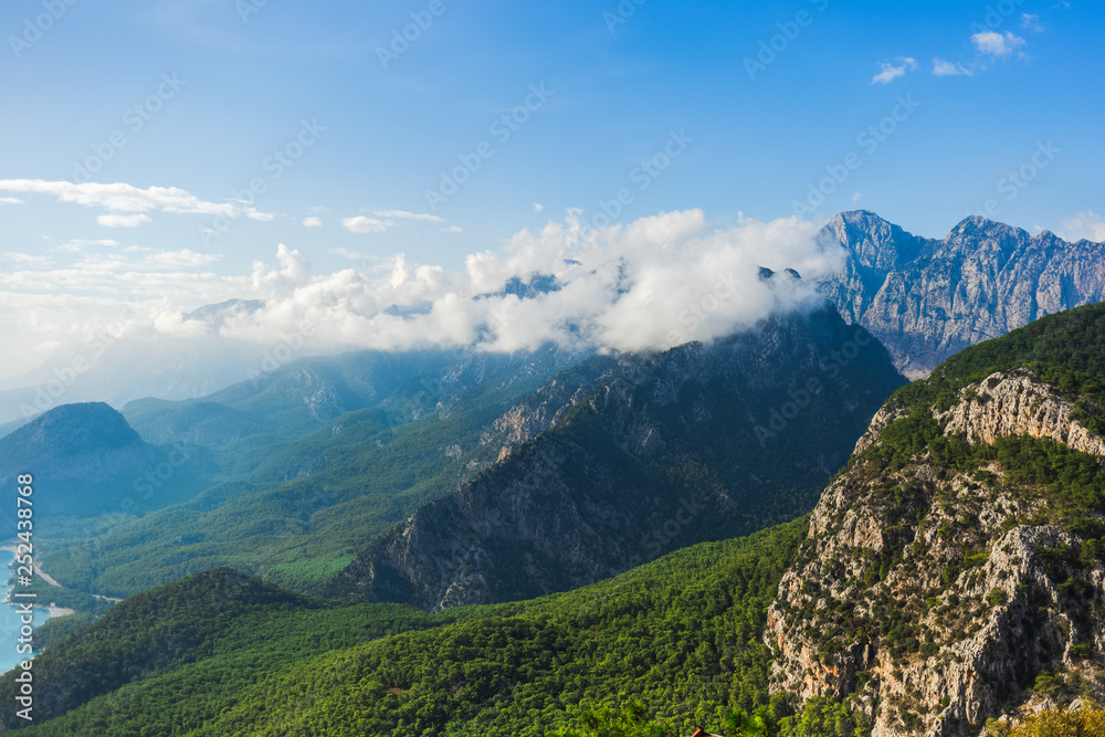 Mountain peaks and amazing cloudy sky. Natural beautiful background. Horizontal color photography.
