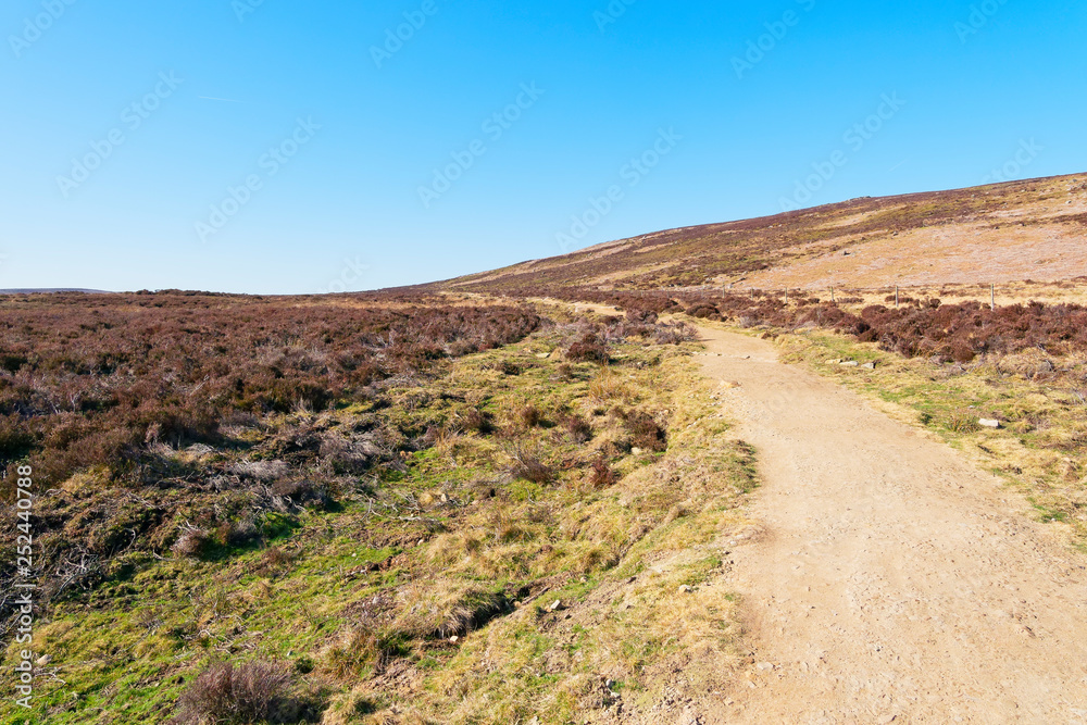 On Derwent Moor in Derbyshire a footpath curves up a gentle slope.