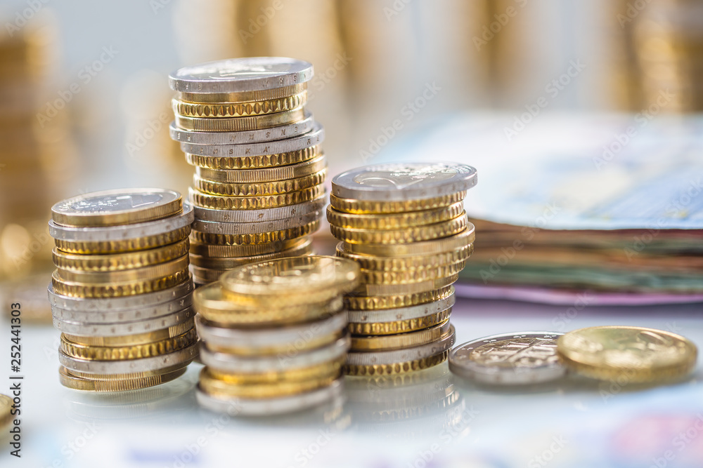 Euro banknotes and coins togetger on white table - close-up Euro banknotes and coins togetger on white table - close-up