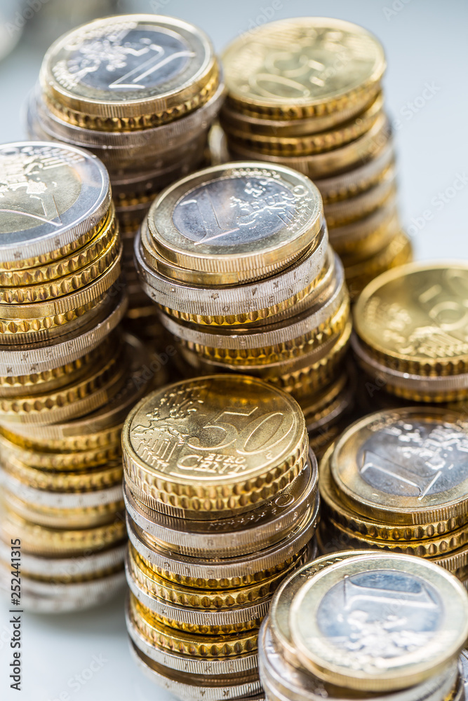 Towers with euro coins stacked together - close-up Towers with euro coins stacked together - close-up