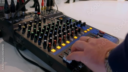 the sound engineer works on the sound unit DJ working on the sound mixer console	
