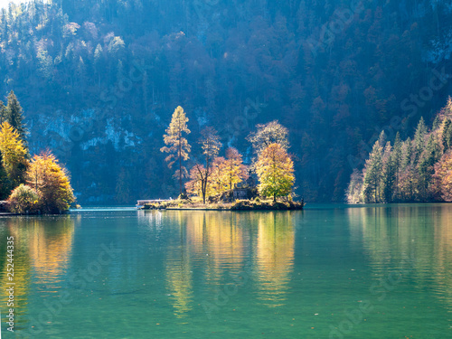 Image of lake koenigssee in berchtesgarden germany during autumn with beautiful colorful trees and island photo