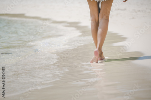 Travel woman foot on beach