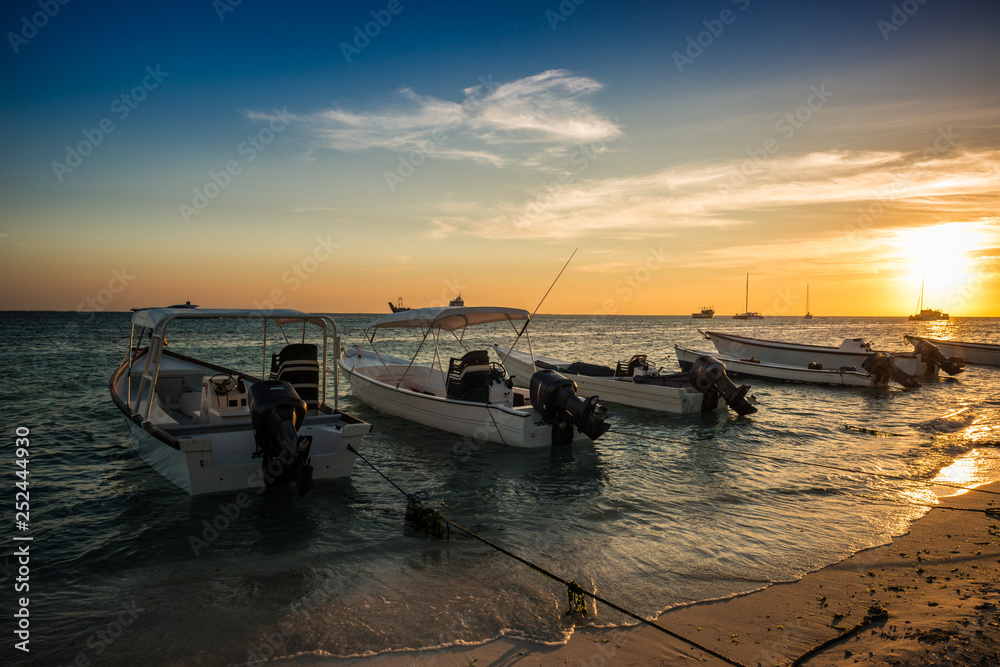 Boats anchored during a dramatic and beautiful sunset. Los Roques National Park 