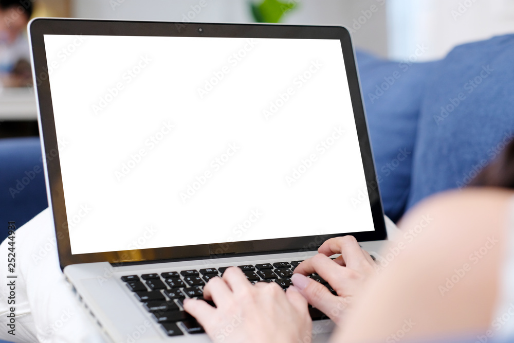 Young asian woman using laptop computer with blank screen for mock up template background, technology and lifestyle, working at home background concept