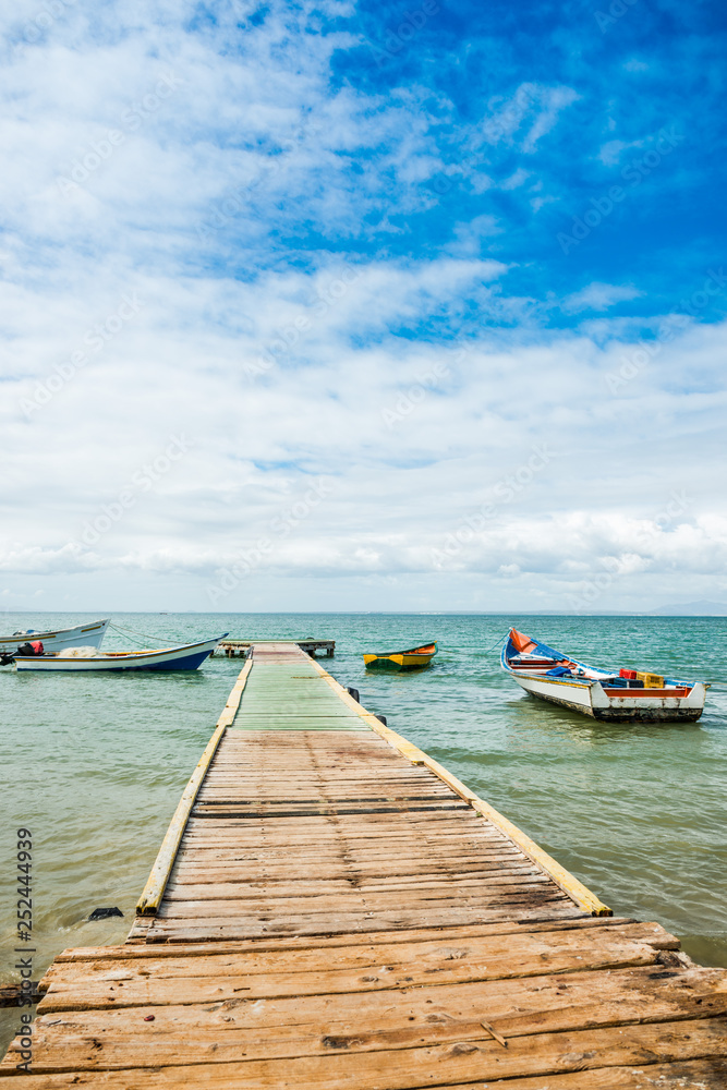Wooden landing stage with anchored boats, Los Roques National Park