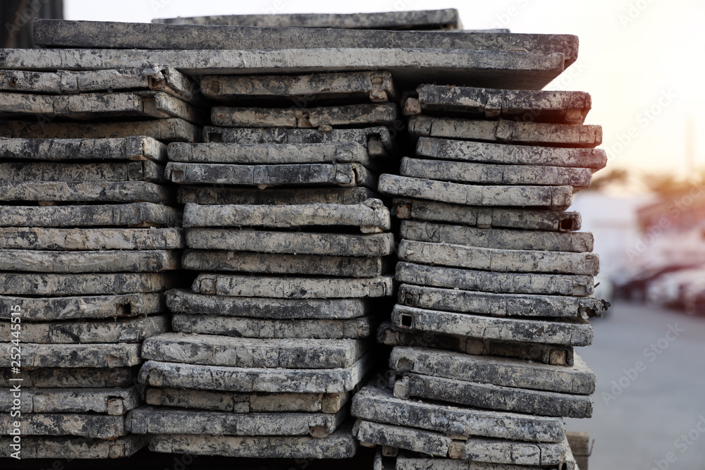 Close up Many slabs are stacked in rows. High as a wall along the road