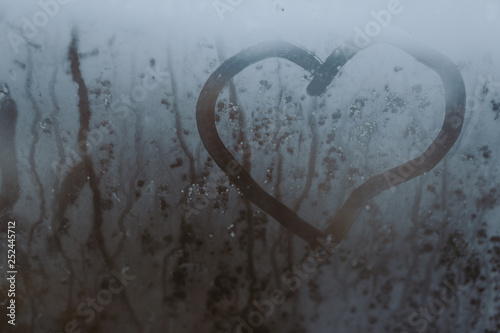 the inscription love on the misted glass.