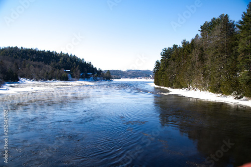 river in winter with mist
