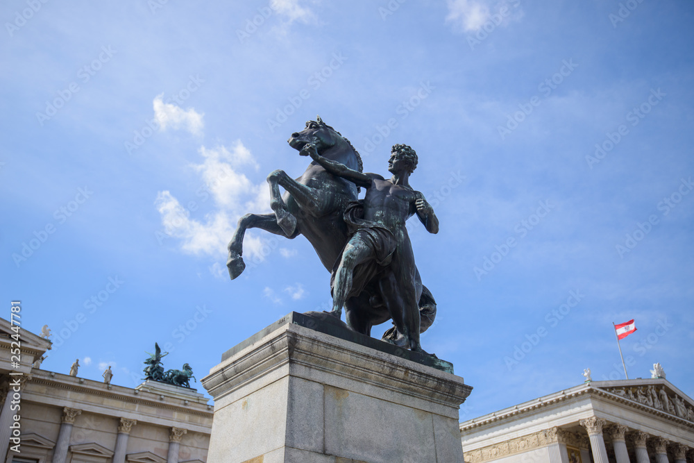 Austrian parliament building with Athena statue on the front in Vienna on the sunrise