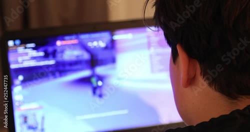Teen playing on laptop computer at home 2