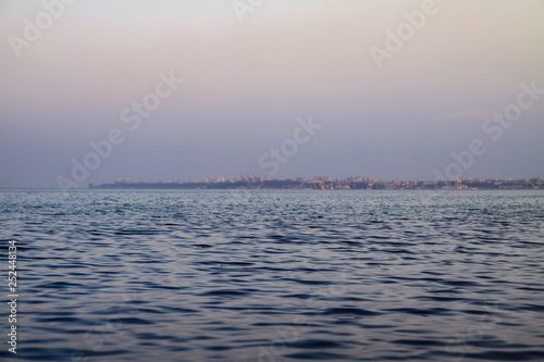 Evening sea on the background of the city. Beautiful landscape for design