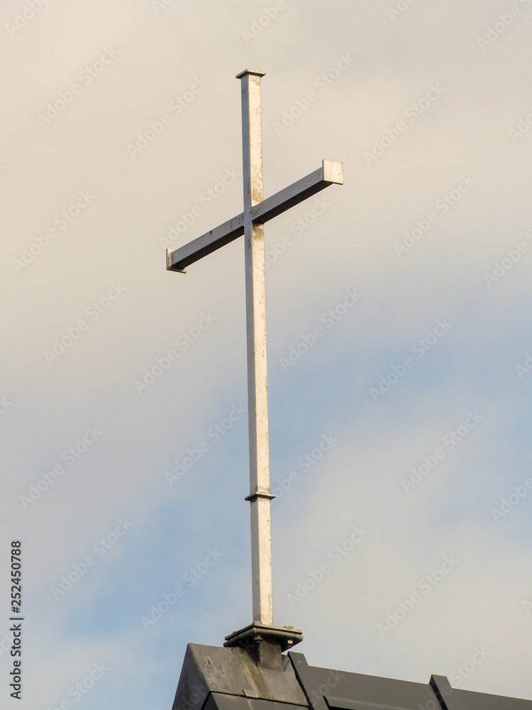 Steel cross on top of church roof