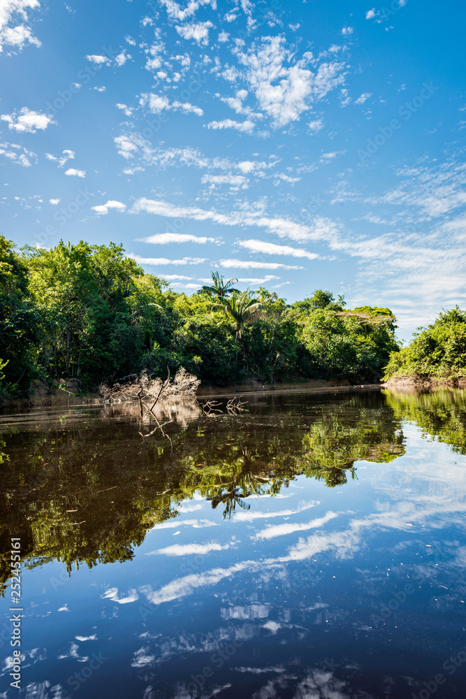Beautiful blue sky reflecting in the Amazonia Basin river. Corocoro river goes along Yutaje Community whicth mean in the native language:  River Foam (Espuma del Rio)