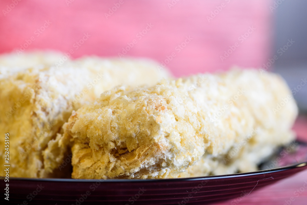 Napoleon cakes on a red wooden background. Napoleon cakes on a red wooden background.