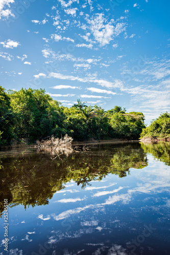 Beautiful blue sky reflecting in the Amazonia Basin river. Corocoro river goes along Yutaje Community whicth mean in the native language: River Foam (Espuma del Rio)