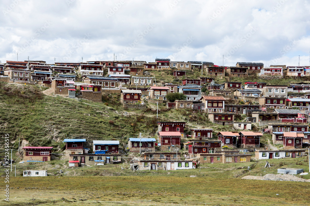 Colorful village on the hill,  in the grasslands of Tagong, Sichuan, China.