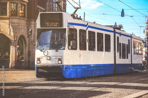 Blue city tram on street in Amsterdam, Netherland