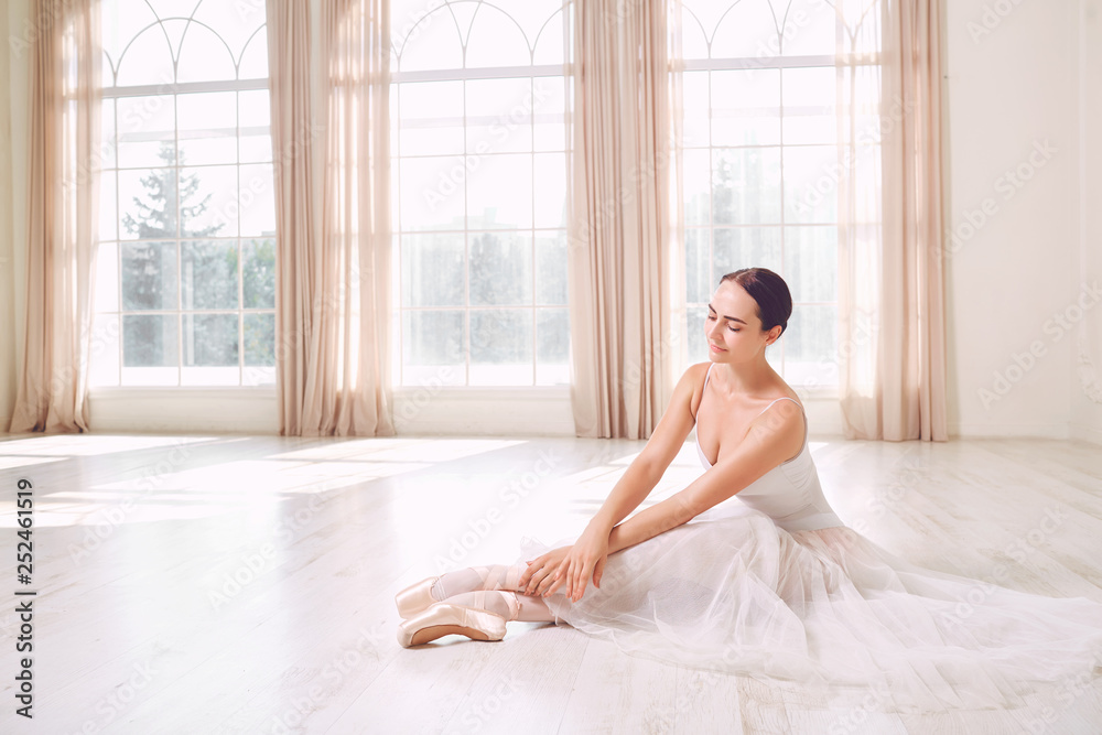Young ballerina posing on the floor Young ballerina posing on the floor