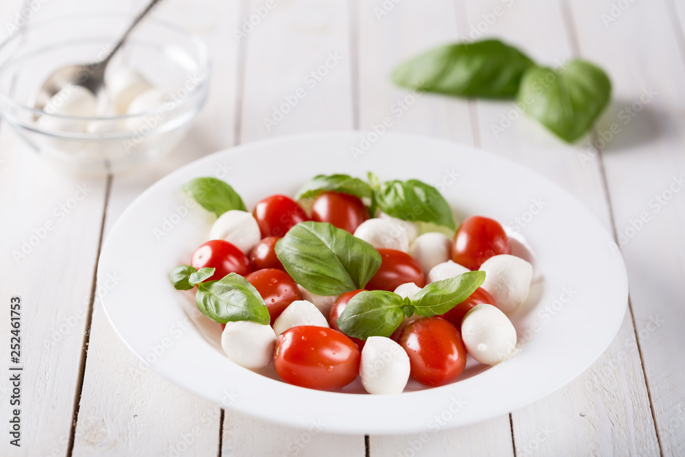 Dish with fresh caprese salad isolated on white Dish with fresh caprese salad isolated on white