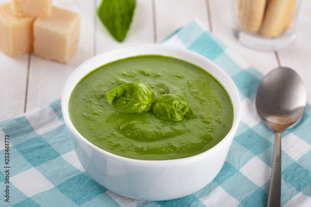 Green cream soup of spinach and chickpeas on concrete wood background Green cream soup of spinach and chickpeas on concrete wood background