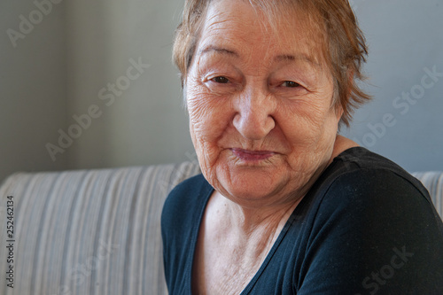 elderly retired woman with hearing impairment received hearing aid of latest modification in center of social protection and tries it on. Help for pensioners and people with disabilities