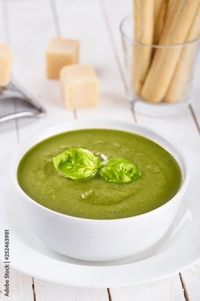 Green cream soup of spinach and chickpeas on concrete wood background Green cream soup of spinach and chickpeas on concrete wood background