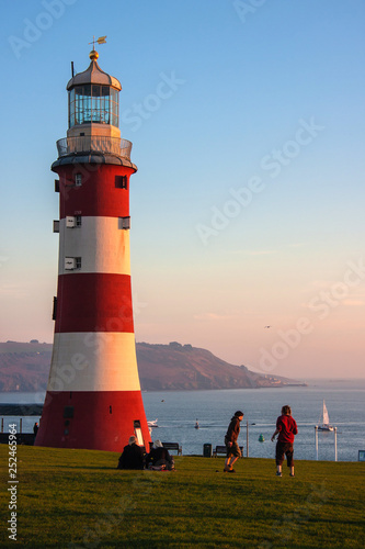 lighthouse at Plymouth hoe at sunset photo