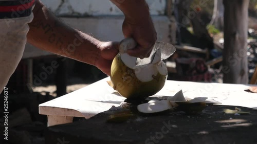 Man chopping a fresh coconut in Mexico