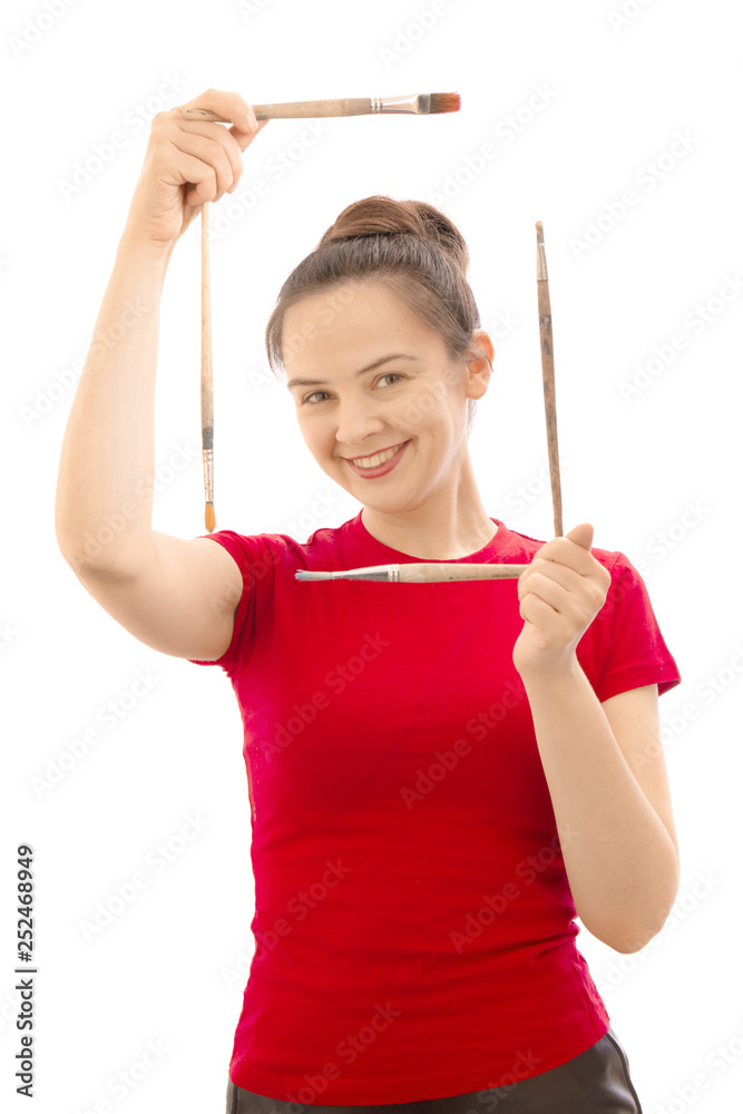 Portrait happy artist painter girl smiling and holding a frame of brushes in astudio. isolated on white Portrait happy artist painter girl smiling and holding a frame of brushes in astudio. isolated on white
