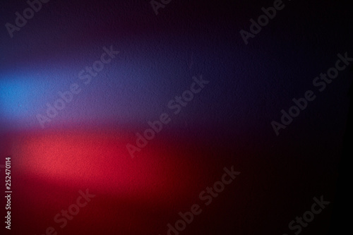 On a dark gradient background the volume blurry glow of red and violet color