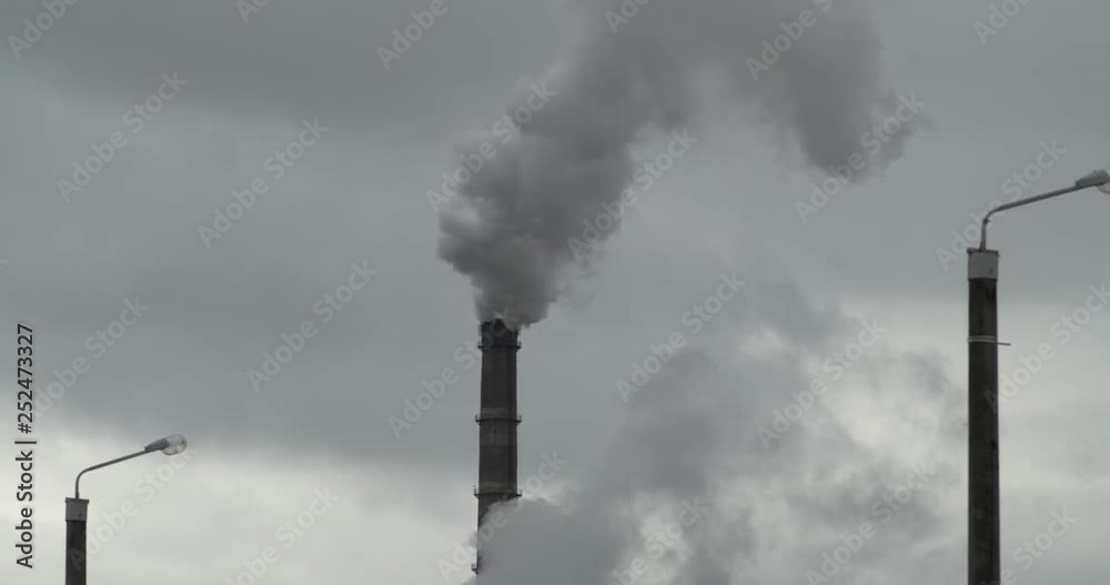 Pollution by an old coal-fired power plant. From the chimney there is acrid gray smoke. Close-up. Slow motion. 4K. Pollution by an old coal-fired power plant. From the chimney there is acrid gray smoke. Close-up. Slow motion. 4K.
