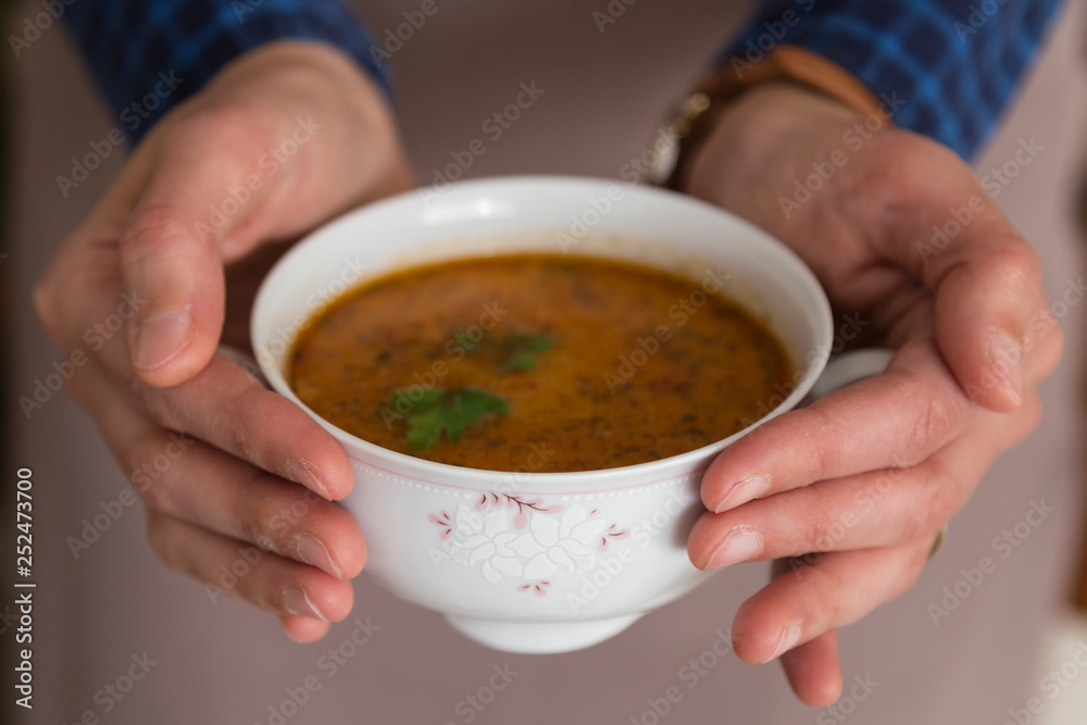 the Tarhana soup in the bowl that the woman hold it for kitchen and food concept. the Tarhana soup in the bowl that the woman hold it for kitchen and food concept.