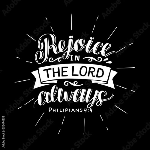 Hand lettering with bible verse Rejoice in the Lord always on black background.