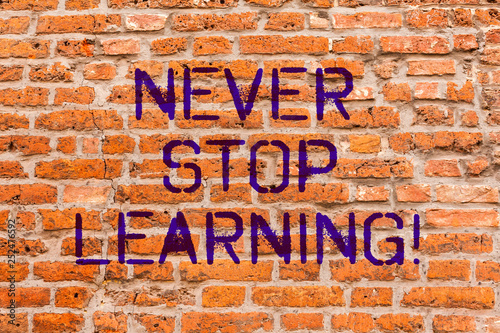 Conceptual hand writing showing Never Stop Learning. Business photo showcasing Keep educating yourself Improve Skills Brick Wall art like Graffiti motivational written on wall