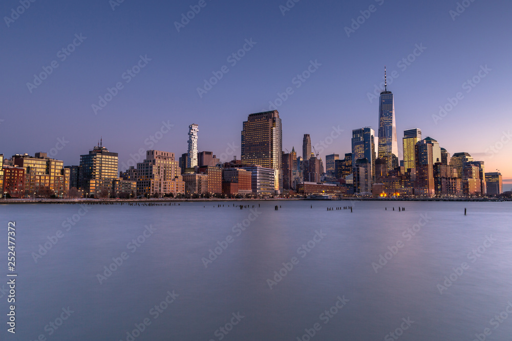 Financial District from Hudson river at twilight with long exposure