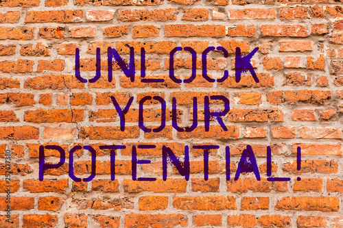 Conceptual hand writing showing Unlock Your Potential. Business photo showcasing Reveal talent Sow Skills Abilities Brick Wall art like Graffiti motivational written on wall