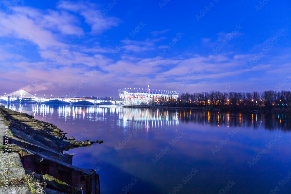 Obraz premium WARSAW, POLAND - FEBRUARY 14, 2019:Night illumination of the National Stadium in Warsaw, February 2019. High-tech venue for sporting events, gigs and park during summer, plus a choice of guided tours.