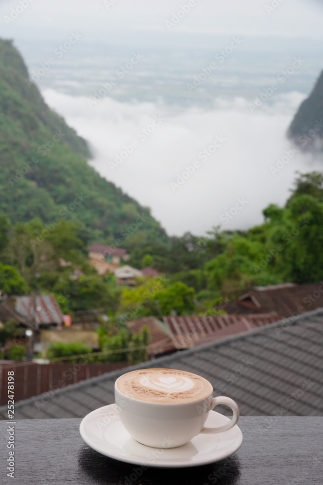 a cup of coffee with beautiful valley