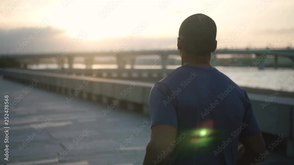 Portrait face of happy african american beautiful adult man active training and jogging race in slow motion. Young african black active mixed race sportsman male doing activity running away and