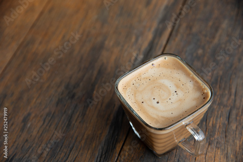 a cup of coffee on wood background