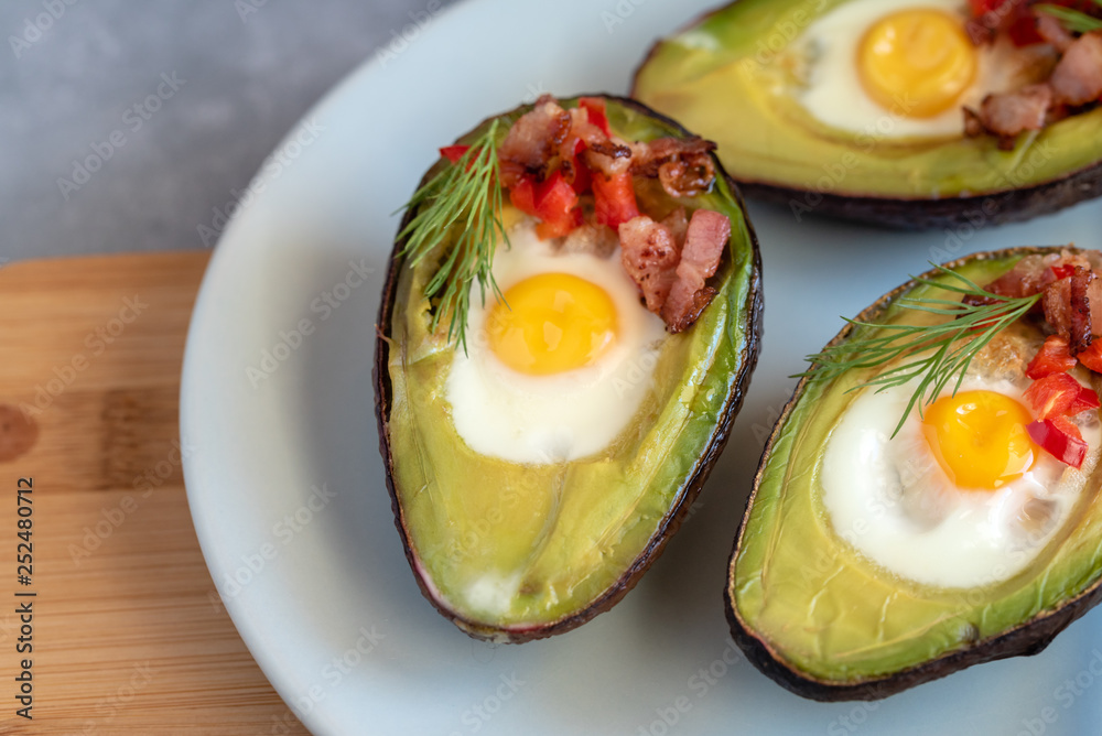 Quail eggs baked in avocado with bacon, red paprika and dill. Quail eggs baked in avocado with bacon, red paprika and dill.