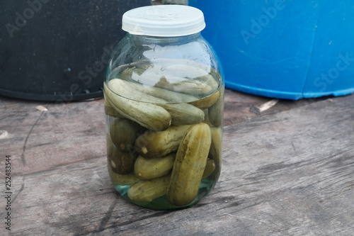Pickled cucumbers in a bank in winter on the table