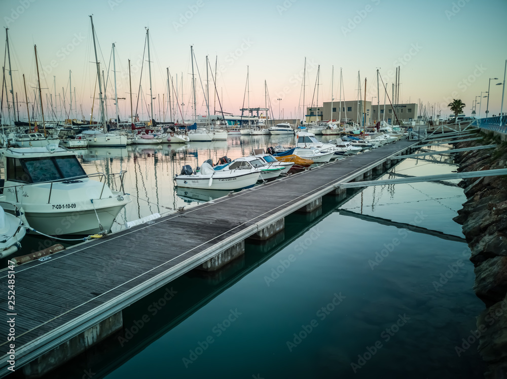Fototapeta premium Burriana marina with boats reflected in the sea