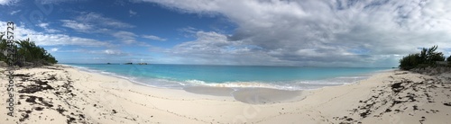 Panoramic view of a beautiful beach with gentle waves and soft white sands in the Bahamas