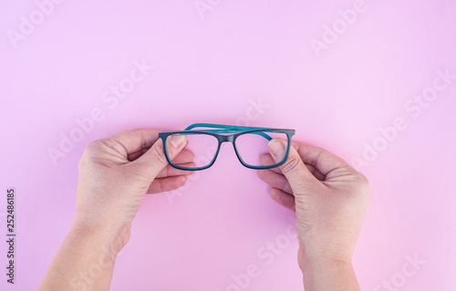 Eyesight concept. Hands holding optical glasses 