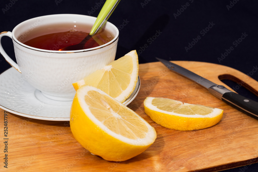 A mug of tea with lemon and chocolate. A mug of tea with lemon and chocolate.